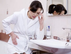person near bathroom sink