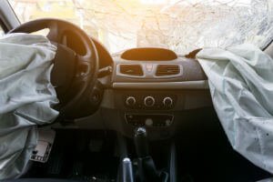 deflated airbags in front seat of car