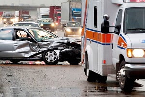 ambulance leaving wrecked car