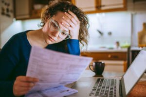 woman concerned with paper in her hand