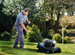 person pushing a mower