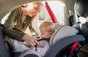 putting child in car seat
