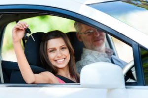 young driver holding keys