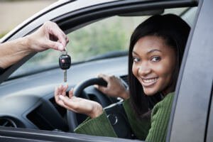 teenager smiling behind the wheel