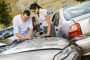 two people in a parking lot car accident