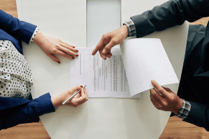 people at table discussing document