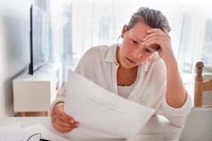 woman at home reading document at table