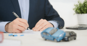 man at table with model cars