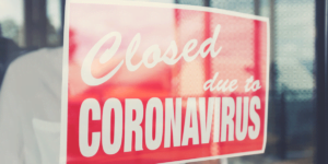 Sign on business window that reads: "closed due to coronavirus"