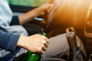 holding bottle of alcohol while driving