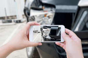 taking pictures of damaged car