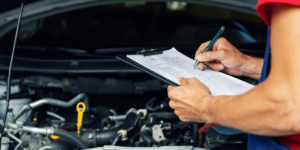 Man performs maintenance check on vehicle