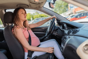 pregnant woman behind wheel