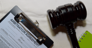 gavel with clipboard for arbitration agreement