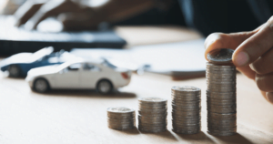 stacking coins on desk with toy cars
