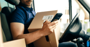 delivery driver checking his phone