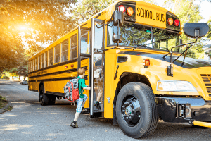 kids getting onto a school bus