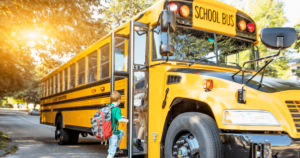 kids getting onto a school bus