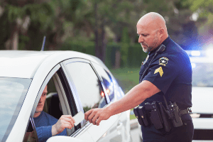 cop issuing a driver a ticket 