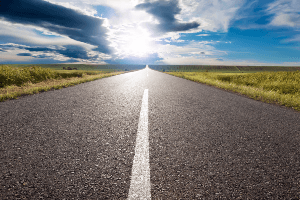 a stretch of flat road under a cloud-covered sky 