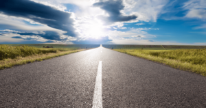 a stretch of flat road under a cloud-covered sky