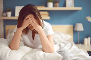 Woman holding her head in pain.