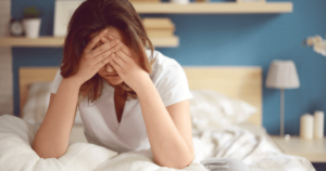 Woman holding her head in pain.