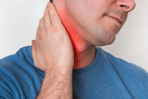 Man holding his neck in pain and discomfort. 