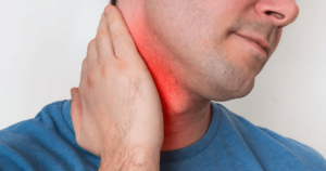Man holding his neck in pain and discomfort.