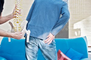 man holding hip in pain