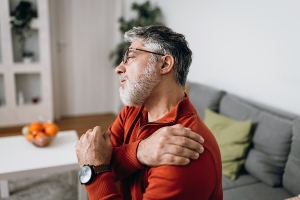 person holding a sore shoulder
