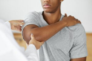 helping patient move arm