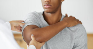 helping patient move arm