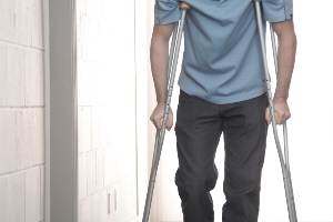 Someone walking with crutches.