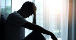 man looking depressed in the dark