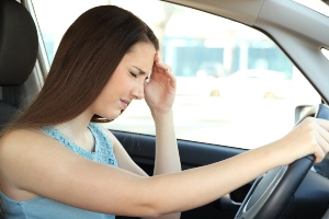 A tired driver behind the wheel.
