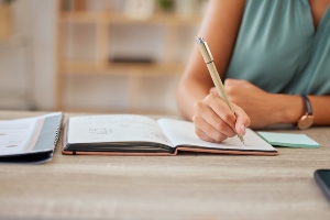 Someone writing in a journal.