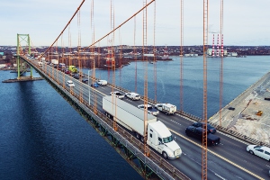 Vehicles passing by on a bridge.