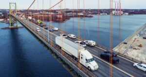 Vehicles passing by on a bridge.