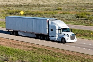 A white truck going down the highway.