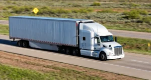 A white truck going down the highway.