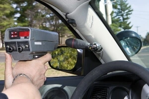A police speedometer on the road.