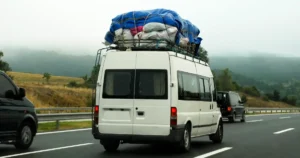 white van overloaded with cargo - top heavy