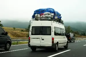 white van overloaded with cargo - top heavy