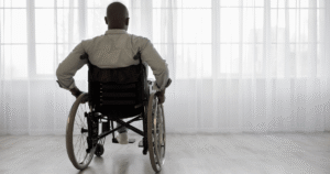 Injured man in wheelchair at window