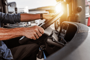 close-up of truck driver behind the wheel